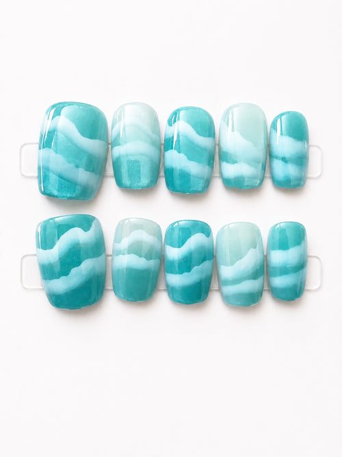 Medium aqua turquoise short square press-on nails with white wave pattern