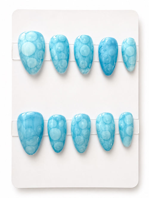 Blue medium press-on nails with translucent bubble pattern