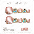 Blush pink and gold press-on toe nails with iridescent gem accents