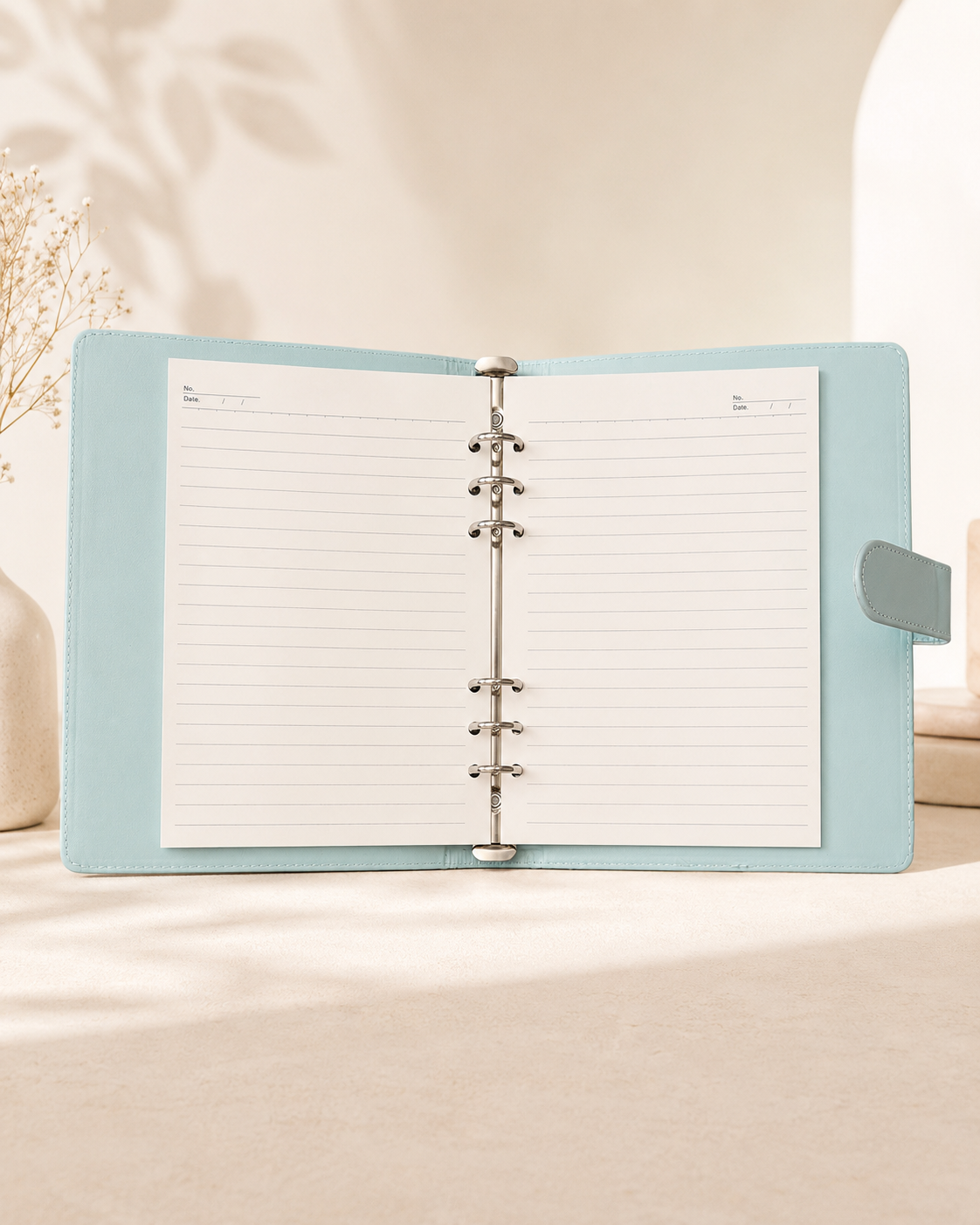 Pastel blue A5 binder open with lined paper inserts
