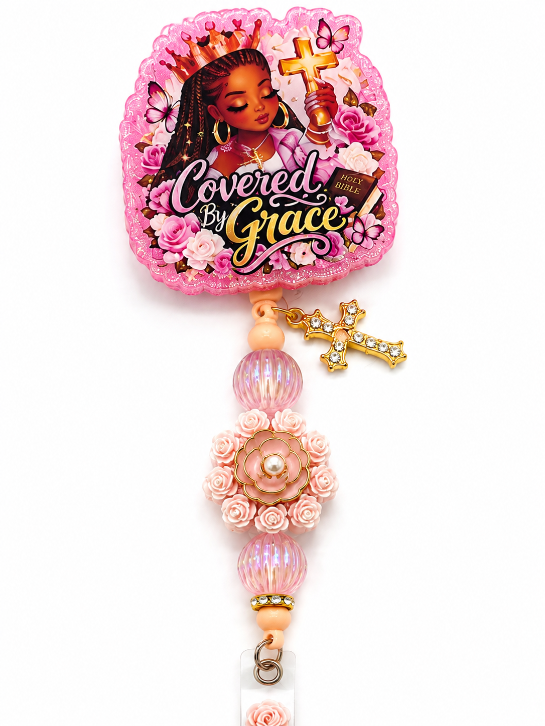 Close-up of Covered by Grace pink floral beaded badge reel with gold cross charm