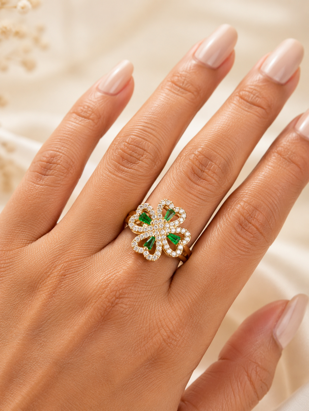 Emerald Clover Bloom adjustable gold spinner ring with green stones and clear crystals