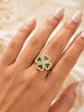 Emerald Clover Bloom adjustable gold spinner ring with green stones and clear crystals