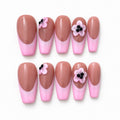 Pink French tip press-on nails with flower accents