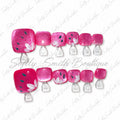Hot pink glitter press-on toe nails with white lotus flower accents