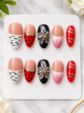 Red black and nude press-on nails with floral animal print and gold accents