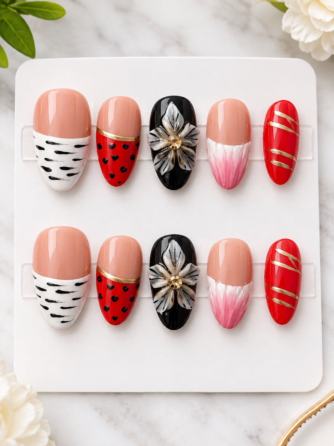 Red black and nude press-on nails with floral animal print and gold accents