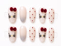 Medium nude press-on nails with red velvet bow kitty accents